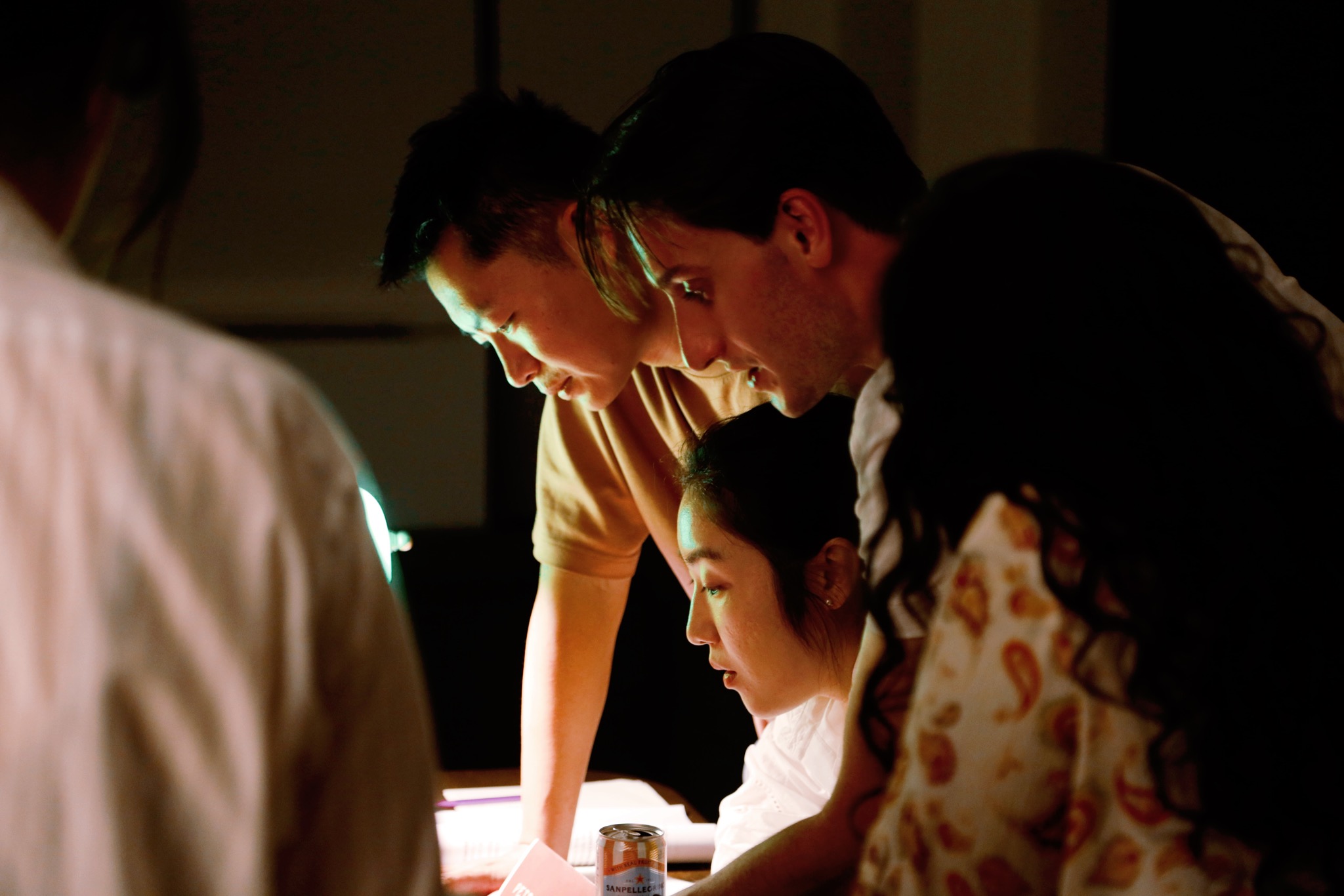 Players conferring in lamplight